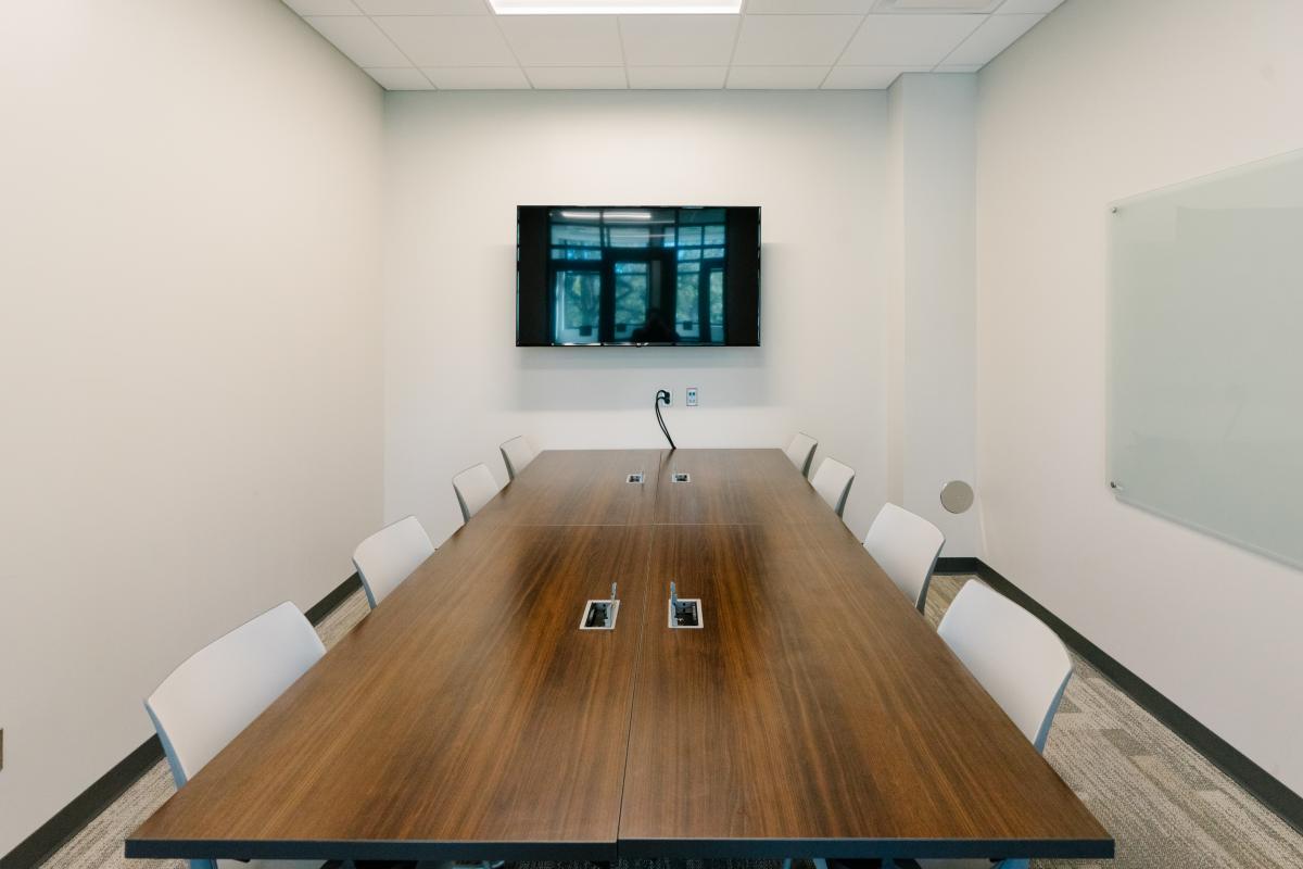 Group Study Room A with a table and six chairs facing the TV.